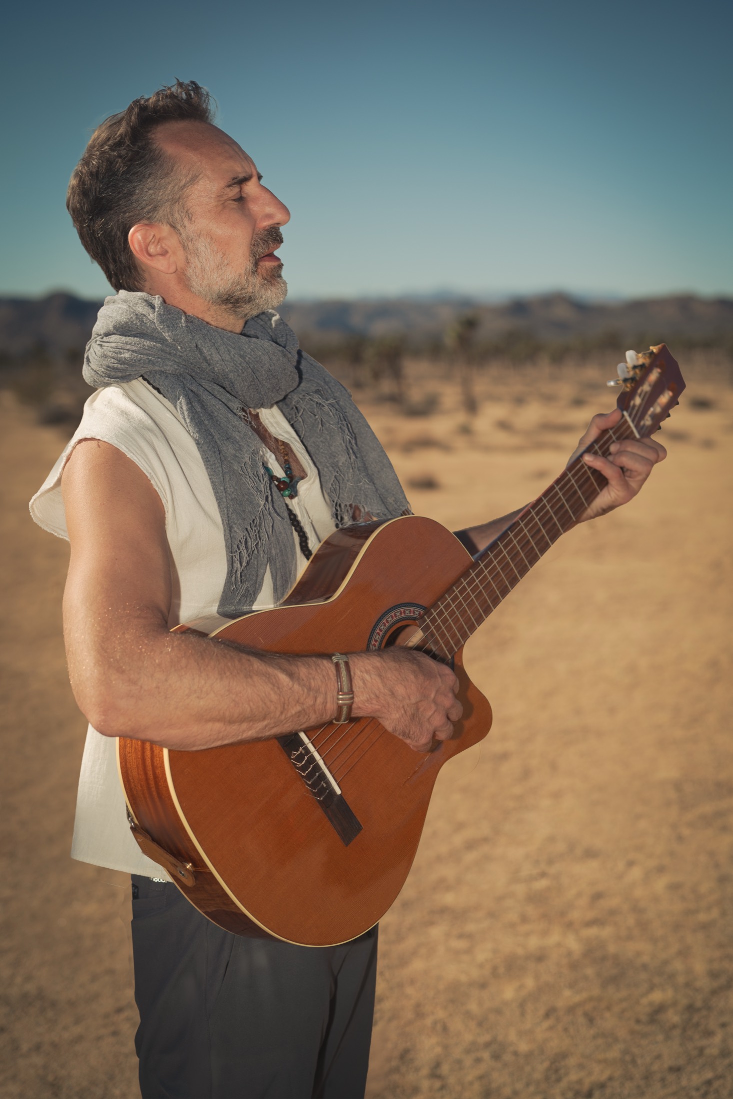 Alex King-Harris (Rara Avis) playing guitar in the desert
