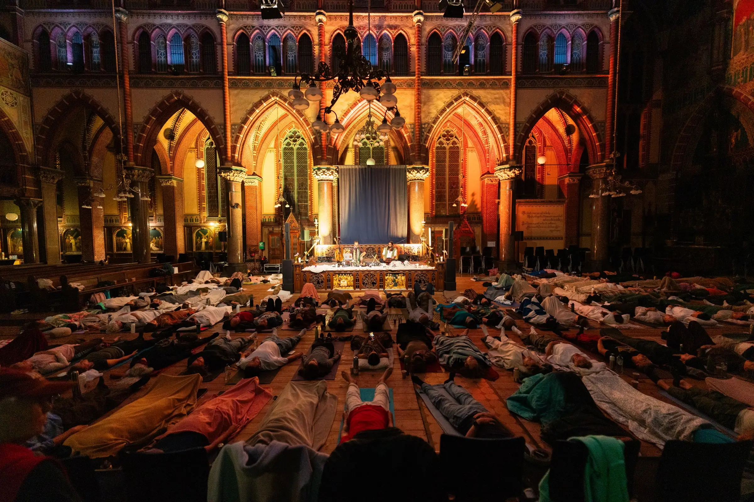 The audience lying down across the church floor while Sandy and Alex play