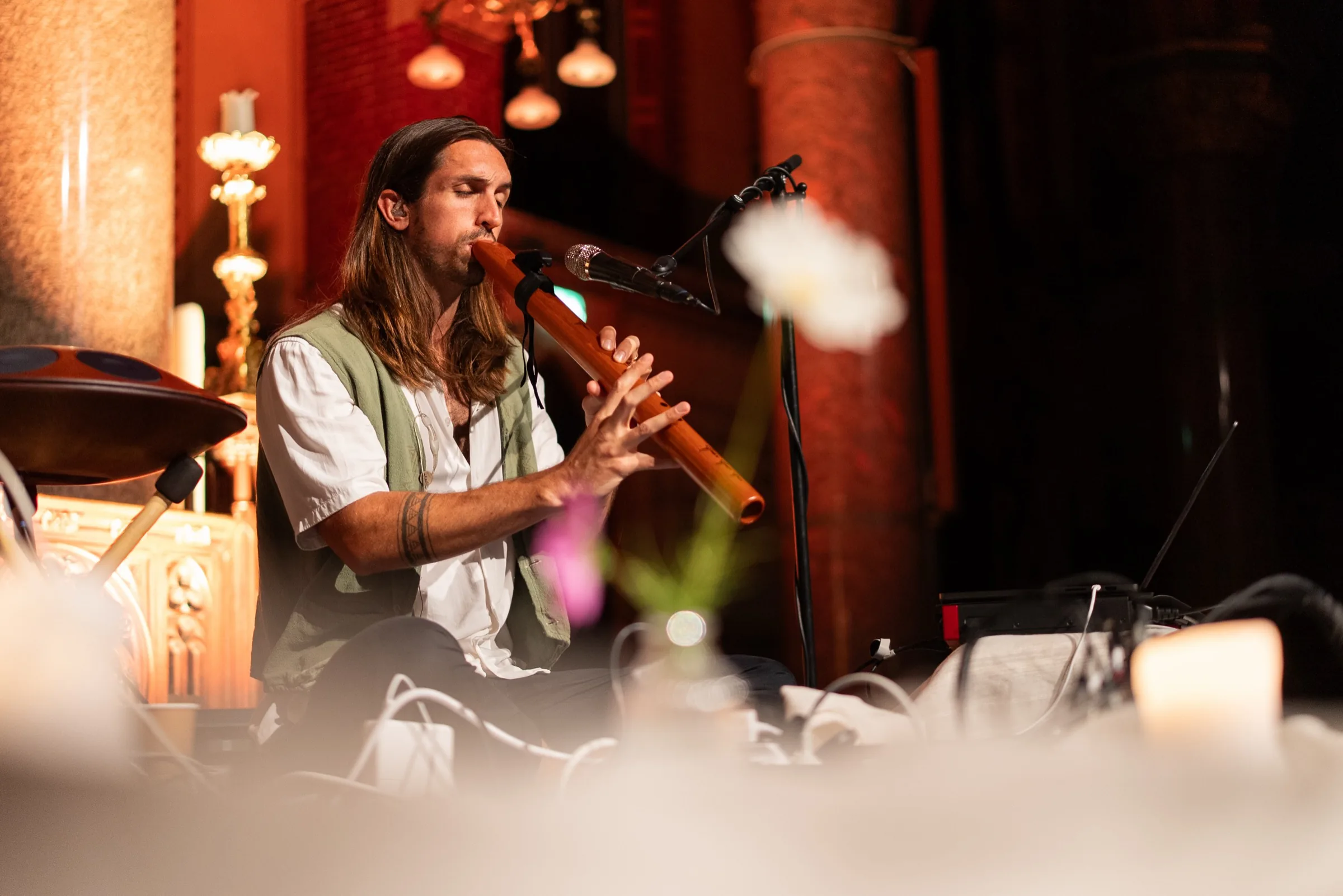 Sandy playing a wooden flute during the breathwork concert in Amsterdam