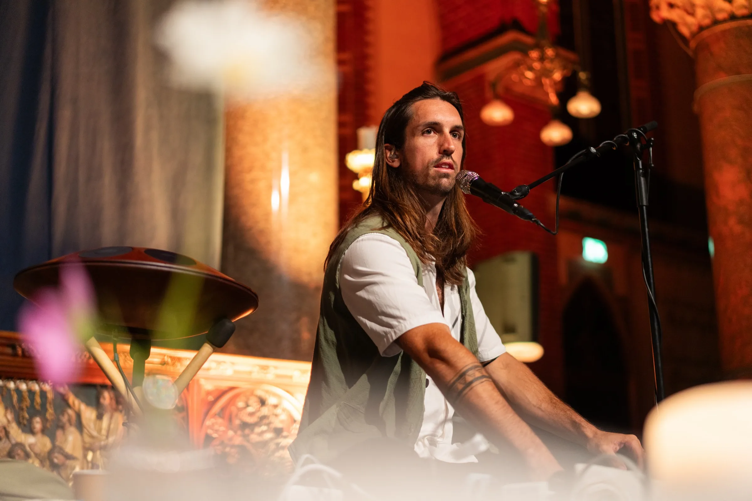 Sandy singing at the microphone during a live breathwork concert in the Dominicuskerk, Amsterdam