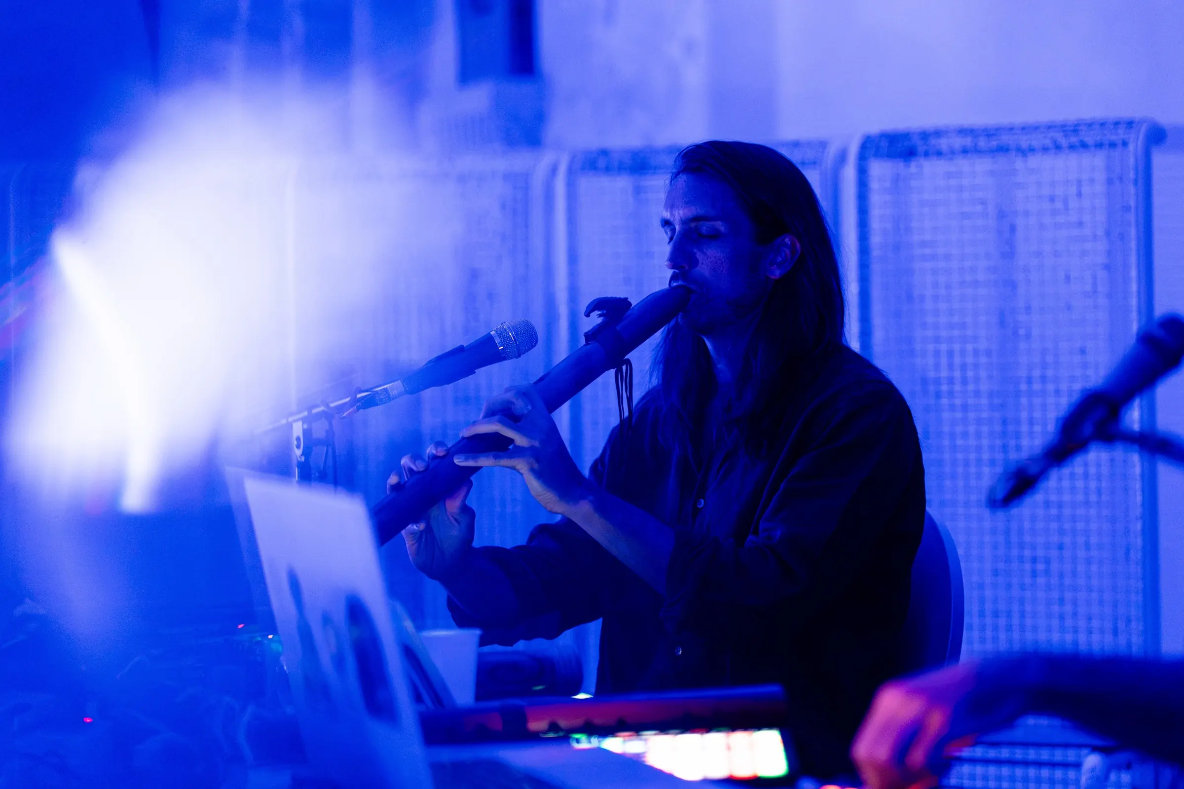 Sandy playing flute in blue light in Budapest